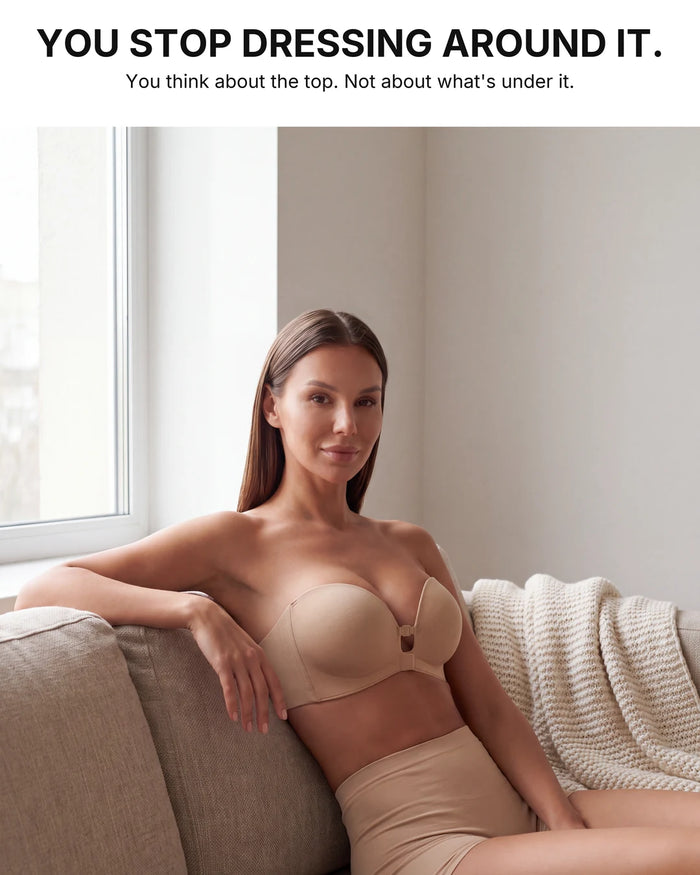 Woman at home on a sofa wearing the beige strapless bra